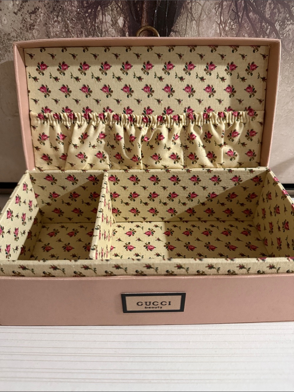 Gucci Beauty pink jewelry and makeup vanity case with a floral-lined interior.